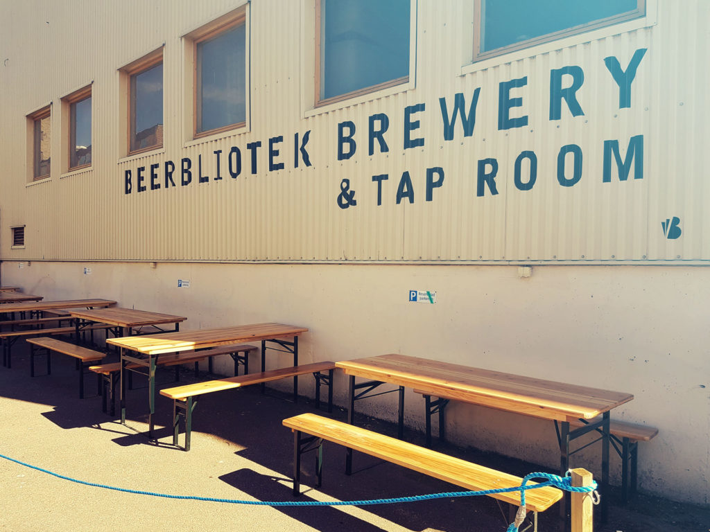 Beerbliotek Brewery & Tap Room outside, with signage, tables and chairs, just before an event.