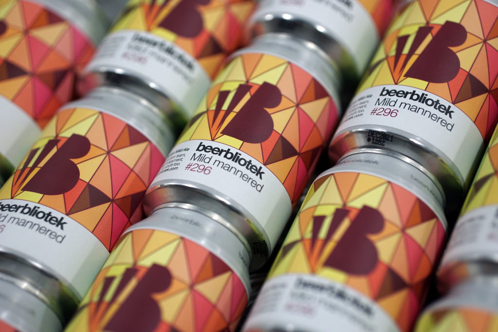 A pattern of cans of Mild mannered, an English Mild Ale, brewed by the Swedish Craft Brewery Beerbliotek.
