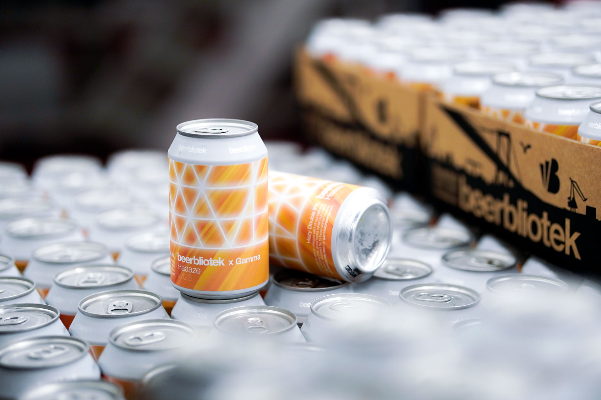 Two cans on packaging day of Haaaze, a Hazy Double IPA. This is a collaboration, brewed in Gothenburg, by Swedish Craft Brewery Beerbliotek, and Danish brewery, Gamma.