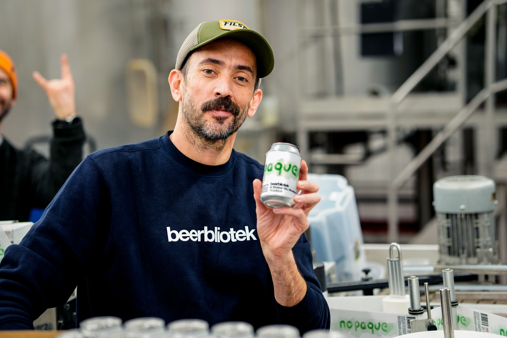 Beerbliotek, a Swedish Craft Brewery based in Gothenburg, Sweden, brewed a West Coast IPA called “Nopaque” with Browar Stu Mostów (The Brewery of a Hundred Bridges) is a craft brewery from Wrocław, Poland. This is a photo of Darryl De Necker holding a can of Nopaque.